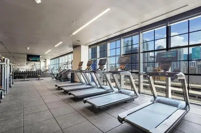 a gym with rows of cardio equipment in a building at Beautiful Studio with Private Balcony Gym & Pool in Miami