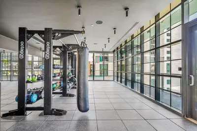 a gym with a punching bag in the middle of a room at Beautiful Studio with Private Balcony Gym & Pool in Miami