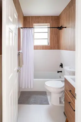 a bathroom with a toilet and a tub and a sink at Designer 2BR Condo, 5 Mins to Sand, Free Parking in Hollywood