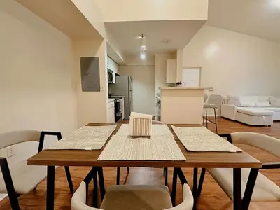 a dining table and chairs in a living room at 1B - 1B Apartment for 3 at Pembroke Pines in Pembroke Pines