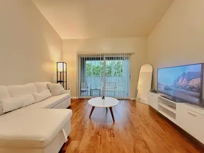 a living room with a white couch and a tv at 1B - 1B Apartment for 3 at Pembroke Pines in Pembroke Pines