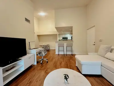 a living room with a white couch and a tv at 1B - 1B Apartment for 3 at Pembroke Pines in Pembroke Pines