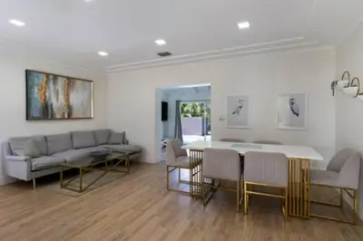 a living room with a couch and a table and chairs at 437 NE 107th · Pool Hot Tub Patio 5 Bedrooms 3 BathsParking in Miami Shores