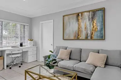 a living room with a couch and a desk at 437 NE 107th · Pool Hot Tub Patio 5 Bedrooms 3 BathsParking in Miami Shores