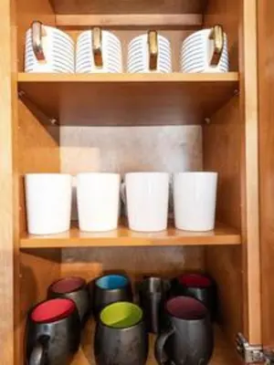 a bunch of cups and plates on a shelf at 427 NE 107th Studio · 6BR 3BA 7 Beds Pool Parking 2 Kitchen in Miami Shores
