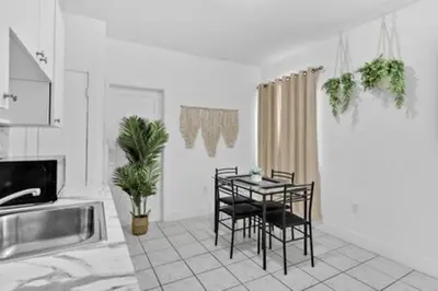 a kitchen with a table and chairs in a room at 1834 SW 27th Ave 2 · Vibrant Miami Getaway 2 Beds Near Beach Port in Miami