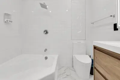 a white bathroom with a toilet and a sink at 1720 Wa Kee 2A · Luxurious 4BR 3BA Retreat in Coconut Grove w Pool in Miami
