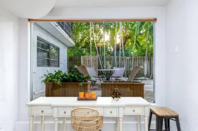 a kitchen with a table and chairs and a patio at 1720 Wa Kee 1B · 4 Queen Beds Sleep 8 Pool Parking Wi-Fi Patio in Miami