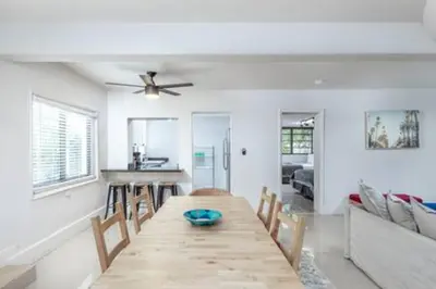 a dining room with a table with chairs and a ceiling fan at 1720 Wa Kee 1B · 4 Queen Beds Sleep 8 Pool Parking Wi-Fi Patio in Miami