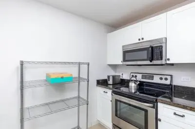 a kitchen with a stove and a microwave at 1720 Wa Kee 1B · 4 Queen Beds Sleep 8 Pool Parking Wi-Fi Patio in Miami