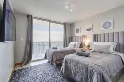 a bedroom with two beds and a large window at Brickell 3802 · Picturesque Bay Views Pool Sleeps 8 Gym in Miami
