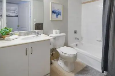 a white bathroom with a toilet and a bath tub at Brickell 3802 · Picturesque Bay Views Pool Sleeps 8 Gym in Miami