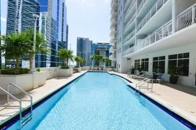 a large swimming pool in the middle of a building at Brickell 3802 · Picturesque Bay Views Pool Sleeps 8 Gym in Miami