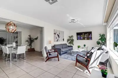 a living room with a couch and a table at 2710 · Heated Pool 7 Beds 5 Baths Sleep 15 Park 4 Car in Miami