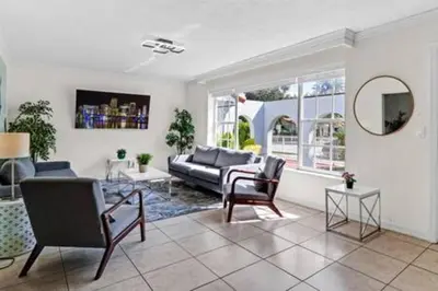 a living room with a couch and chairs and a mirror at 2710 · Heated Pool 7 Beds 5 Baths Sleep 15 Park 4 Car in Miami