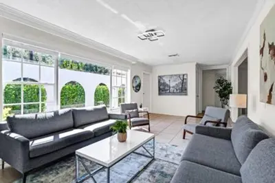 a living room with a couch and a table at 2710 · Heated Pool 7 Beds 5 Baths Sleep 15 Park 4 Car in Miami