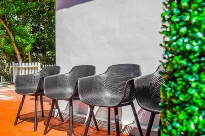 a row of chairs sitting next to a wall at 2710 · Heated Pool 7 Beds 5 Baths Sleep 15 Park 4 Car in Miami