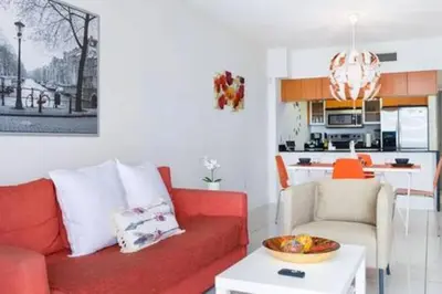 a living room with a red couch and a kitchen at Waterfront 1BR w Bay ViewsBalcony Full Kitchen in Miami