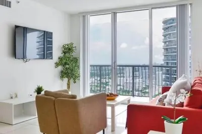 a living room with a red couch and a large window at Waterfront 1BR w Bay ViewsBalcony Full Kitchen in Miami