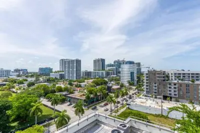 a city skyline with tall buildings and palm trees at Modern 1BR Apt In Edgewater Free Parking in Miami