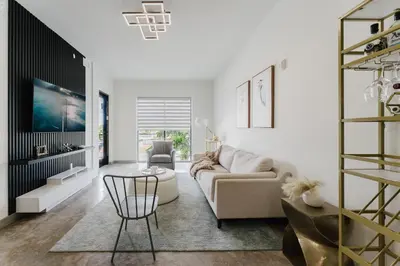 a living room with a couch and a table at KOOSH - Boutique Aparthotel in Fort Lauderdale