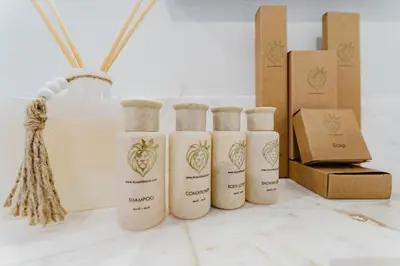 a group of four bottles sitting next to boxes at KOOSH - Boutique Aparthotel in Fort Lauderdale