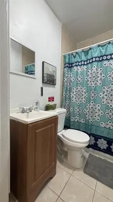 a bathroom with a toilet and a shower curtain at The Studio 6 Little Havana Walk to Marlins Stadium in Miami