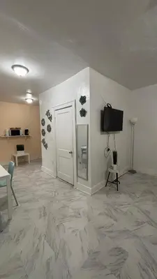 an empty room with a door and a television at The Studio 6 Little Havana Walk to Marlins Stadium in Miami
