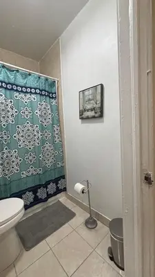 a bathroom with a toilet and a shower curtain at The Studio 6 Little Havana Walk to Marlins Stadium in Miami