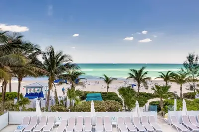 a view of the beach from the balcony of a resort at Marenas Beach Resort Private Luxury Suites in Miami Beach