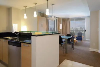 a kitchen and living room with a table and chairs at Marenas Beach Resort Private Luxury Suites in Miami Beach