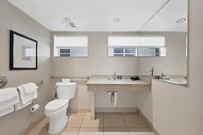 a bathroom with a toilet and a sink at Ocean Drive Apt with Balcony & Rooftop Pool in Miami Beach