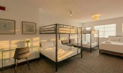 a bedroom with two bunk beds and a couch at Ocean Drive Apt with Balcony & Rooftop Pool in Miami Beach