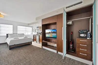 a bedroom with a bed and a flat screen tv at Ocean Drive Apt with Balcony & Rooftop Pool in Miami Beach