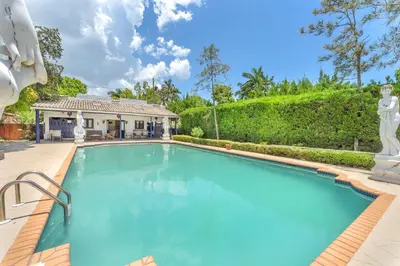a swimming pool in front of a house at Young Mansion Steps To The Beach in Hollywood