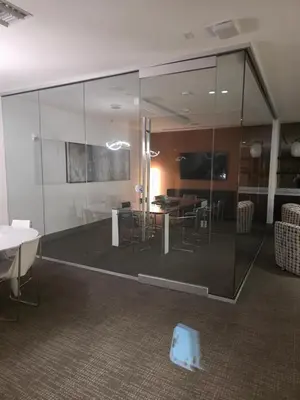 a room with glass walls and a table and chairs at Sweetie Doral studio in Miami