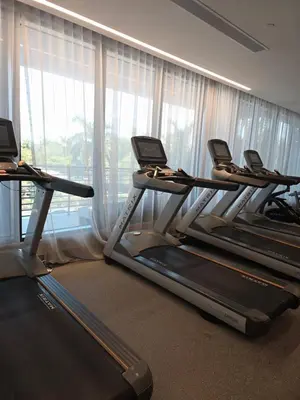 a row of treadmills in a gym with a window at Sweetie Doral studio in Miami