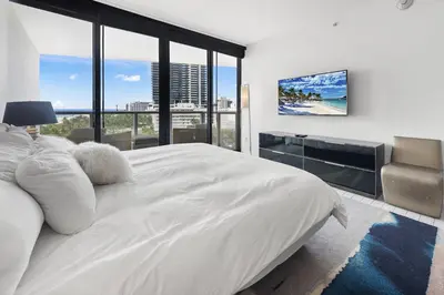 a bedroom with a large white bed and large windows at Oceanview Private Home at South Beach-814 1B in Miami Beach