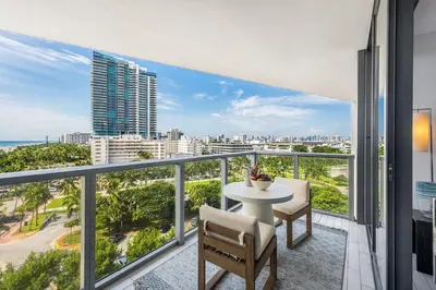 a balcony with a table and chairs and a view of the city at Oceanview Private Home at South Beach-814 1B in Miami Beach