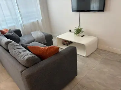 a living room with two couches and a tv at Knickerbocker 102 in Miami Beach