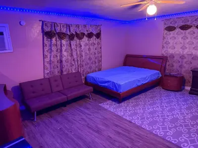 a bedroom with a bed and a couch at The Luxe Loft in Fort Lauderdale