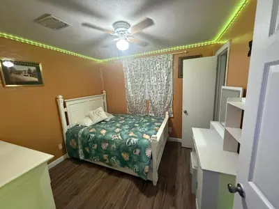 a small bedroom with a bed and a ceiling fan at The Luxe Loft in Fort Lauderdale