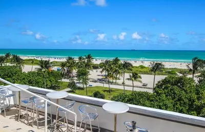 a view of the beach from the balcony of a resort at Spacious APT on South Beach Roof Top Pool & Bar in Miami Beach