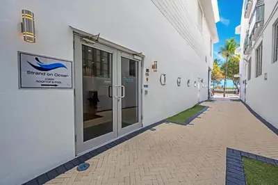 a white building with a sign on the side of it at Spacious APT on South Beach Roof Top Pool & Bar in Miami Beach