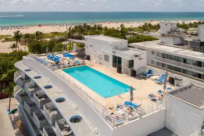 an aerial view of a resort with a swimming pool and the beach at Spacious APT on South Beach Roof Top Pool & Bar in Miami Beach
