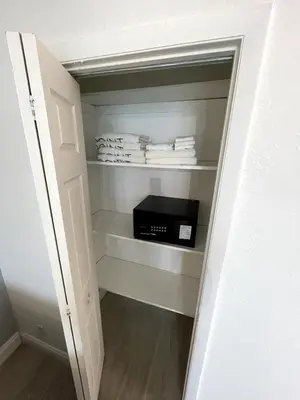 a closet with a door open with a black appliance at Shine Suites Balcony Studio 7 in Miami Beach