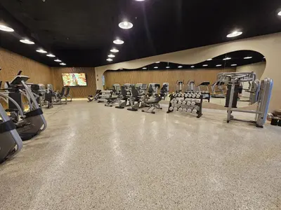 a gym with rows of treadmills and machines at Shine Suites Studio 11 in Miami Beach