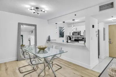 a dining room and kitchen with a glass table and chairs at Amazing property with amenities in Miami