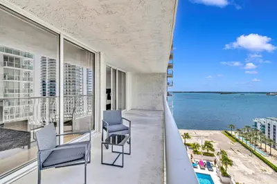 a balcony with two chairs and a view of the ocean at Amazing property with amenities in Miami