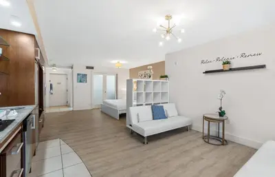 a large living room with a couch and a bed at Heart of South Beach Studio Roof Top Pool Balcony in Miami Beach